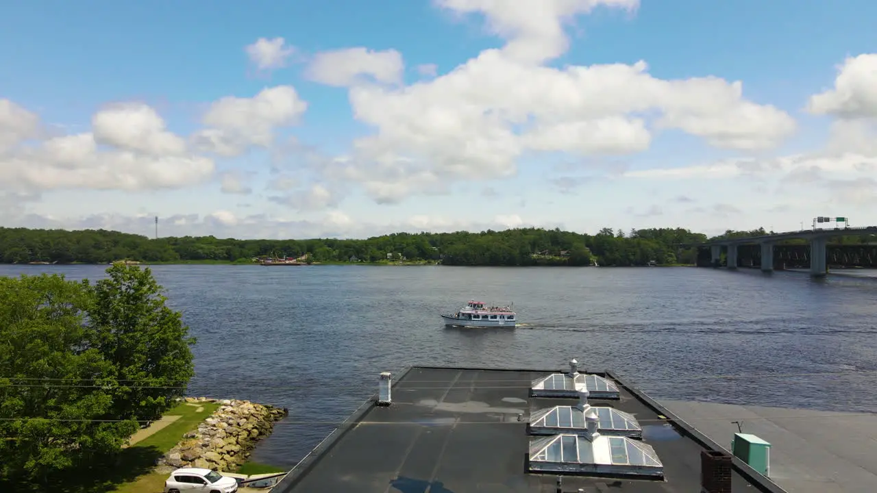 Drone shot descending showing the Kennebec River lowing down to show food stall of Dough Boys fried dough food