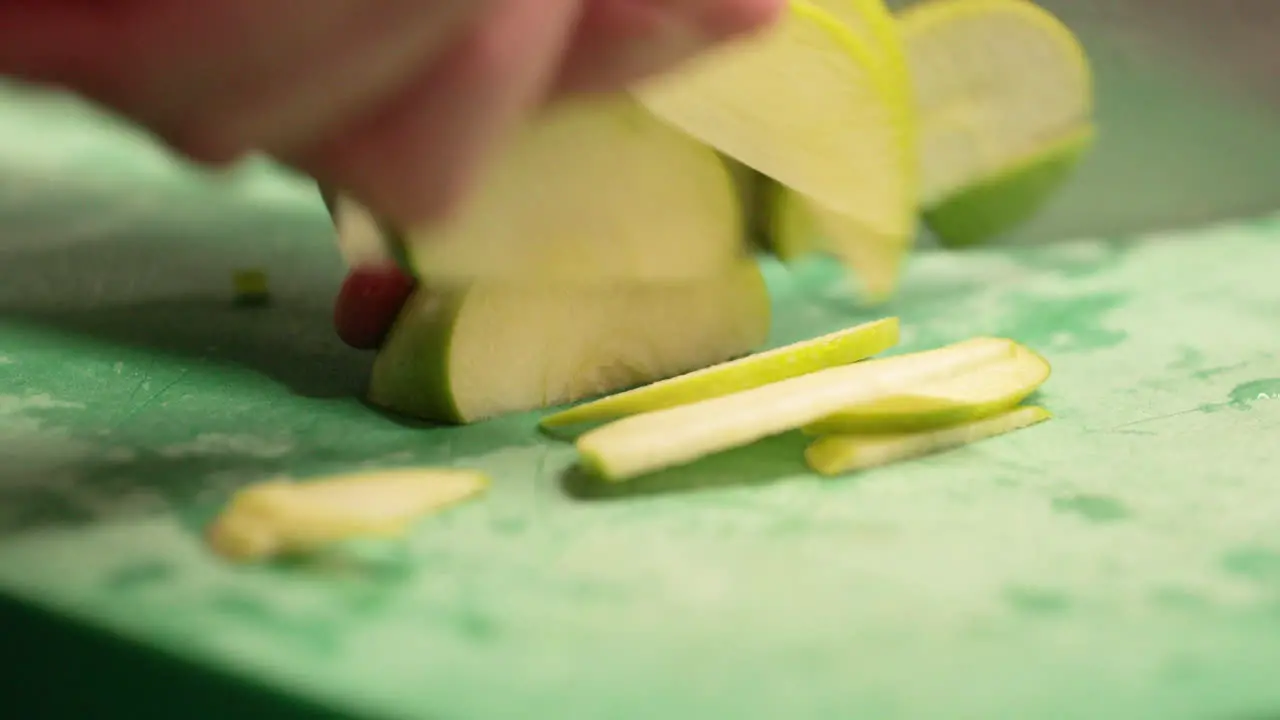 Chef Slicing Fresh Green Apple On The Chopping Board In The Restaurant Kitchen slow motion