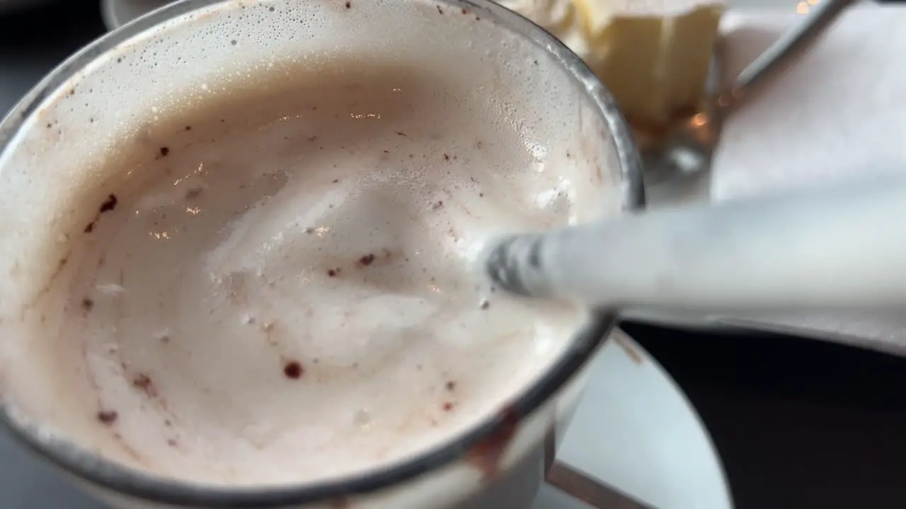 Drinking hot chocolate with cream through a straw