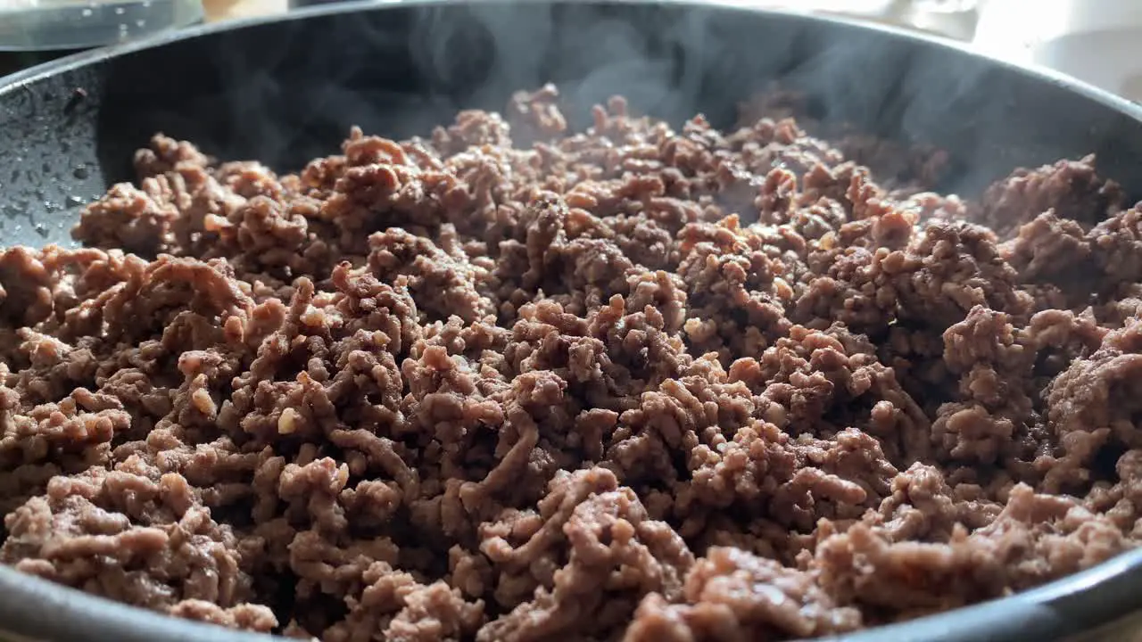 Steaming hot minced meat close up in a frying pan