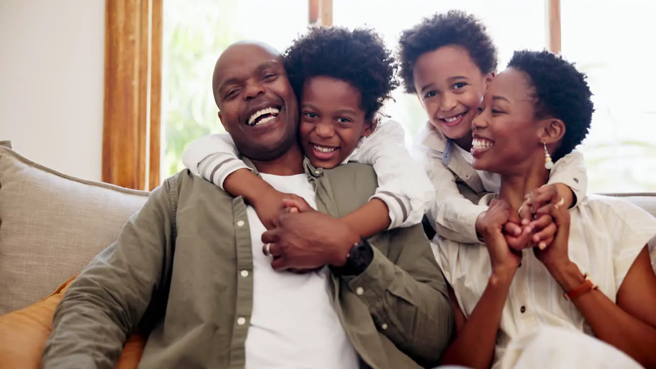 Happy black family hug and relax on sofa