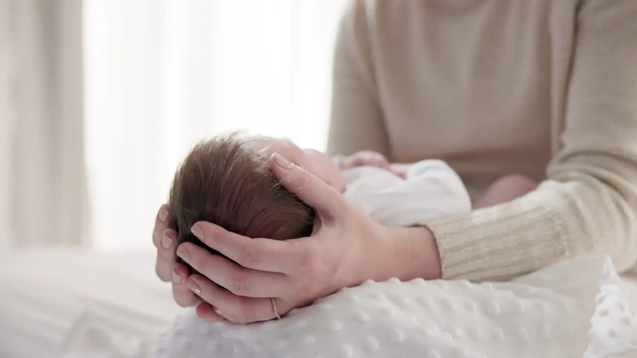 Newborn baby mother and hands on hair with love