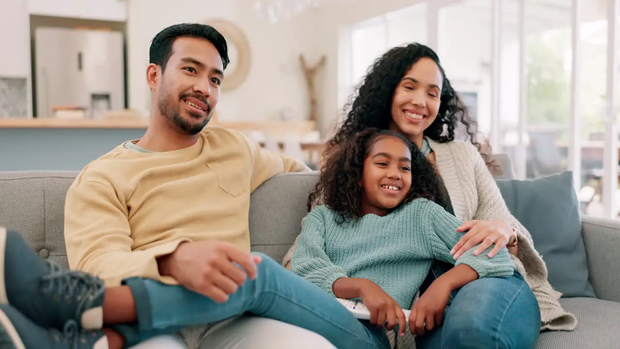 Happy family parents and child watching tv