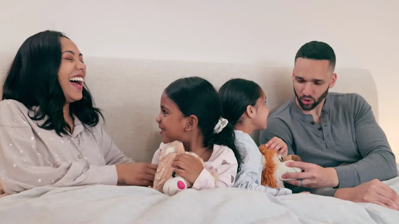 Happy family fun and playing in a bed with hand