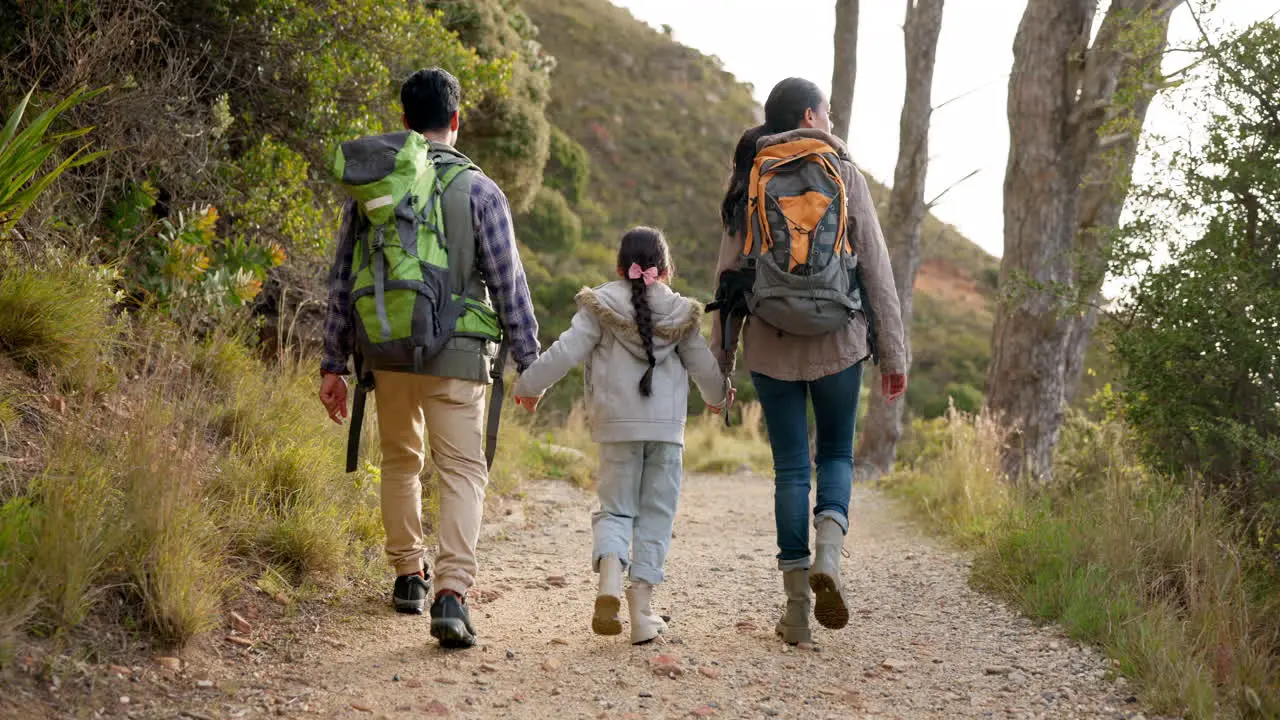 Happy family hiking and holding hands outdoor