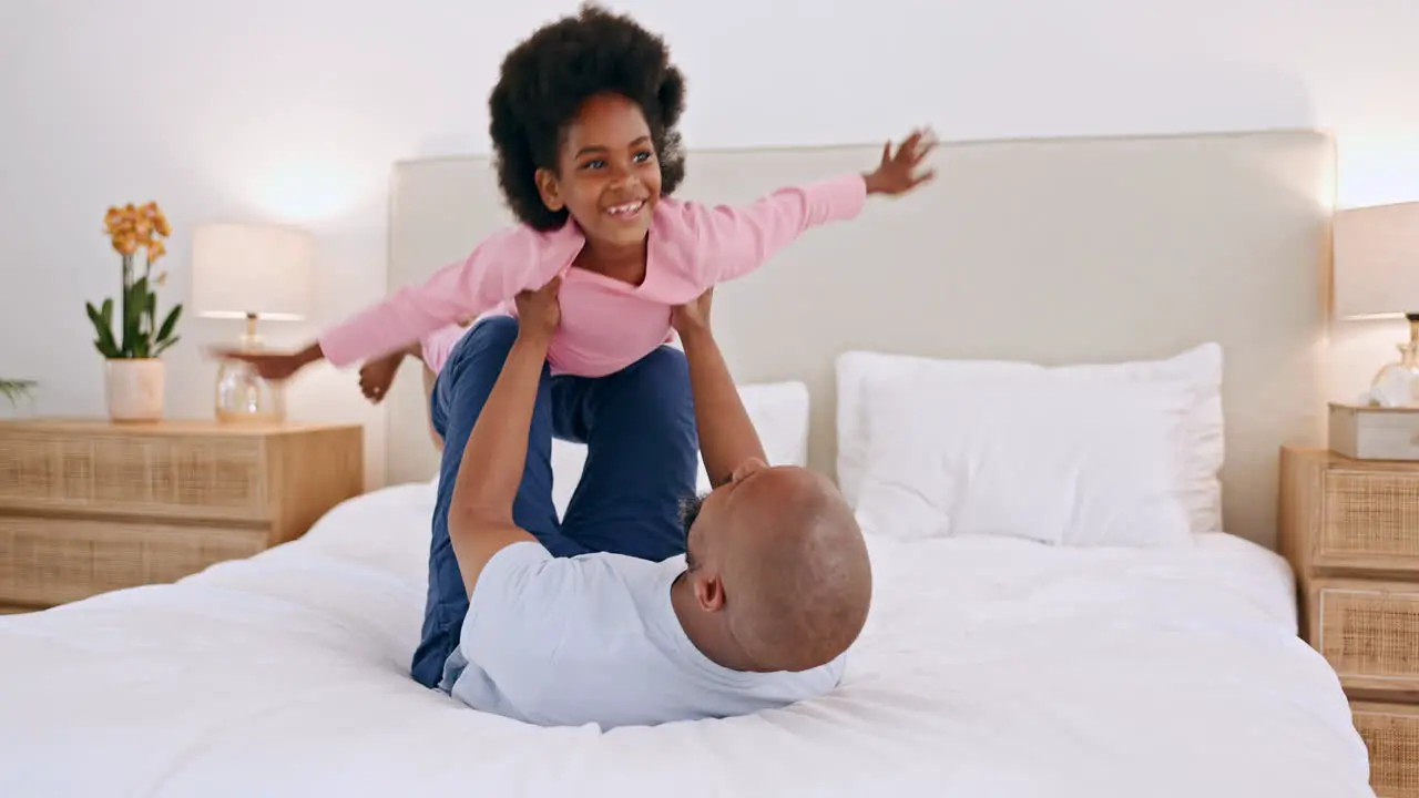 Black family father and a daughter flying