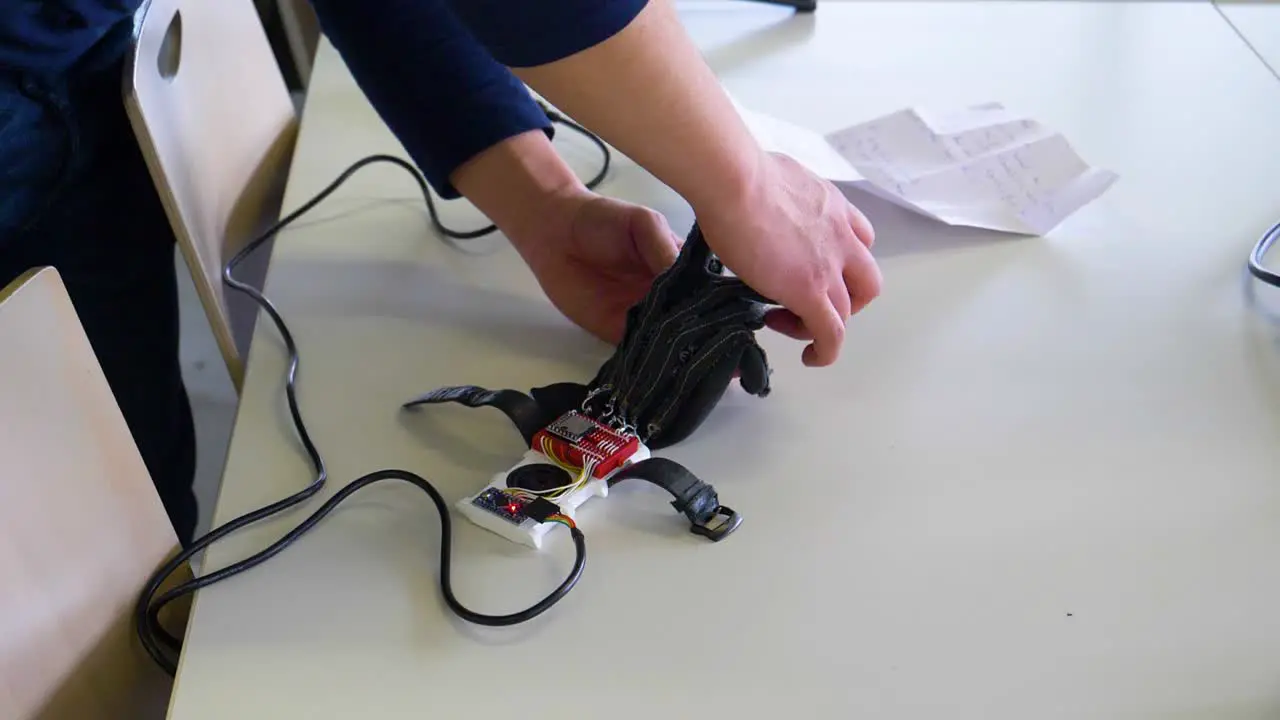 Engineer working on technical glove that allows people to speak