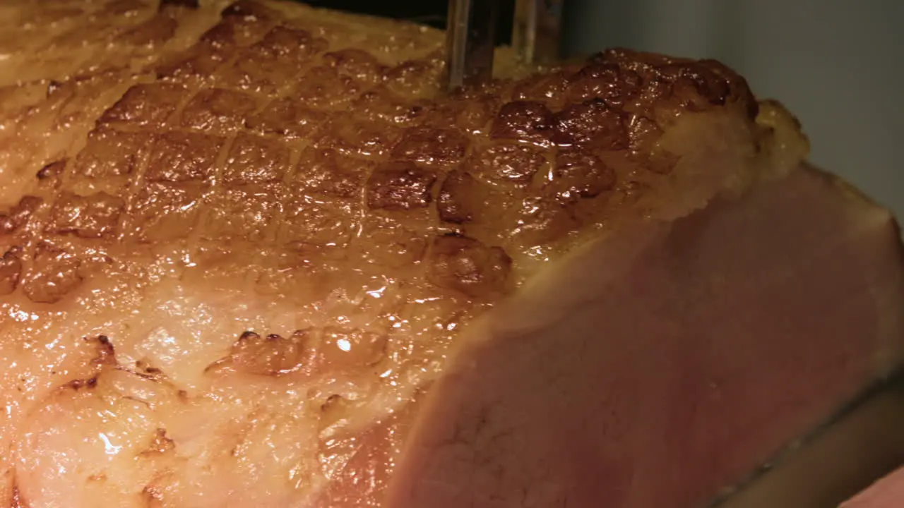 Close Up Of Honey Glazed Ham Being Sliced