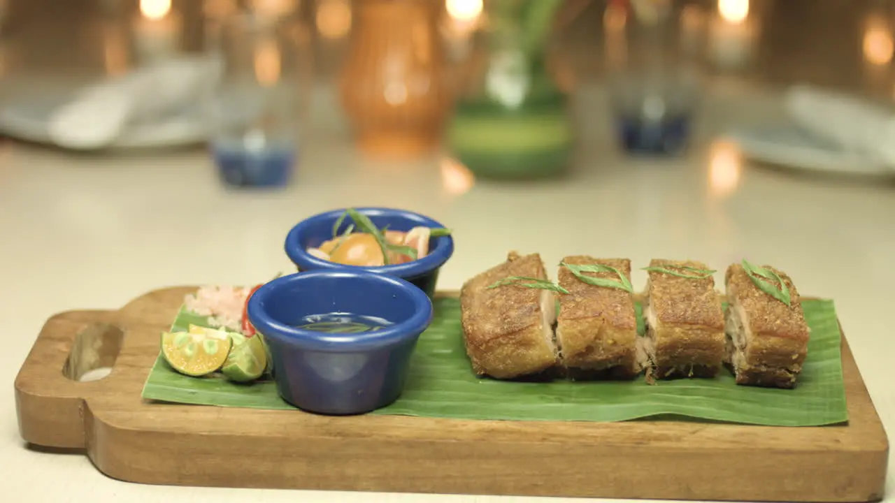 Crispy Lechon Dish With A Candle Light Background 4K