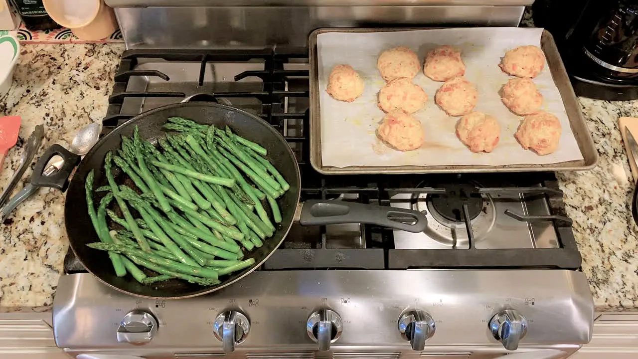 Kitchen stove top with asparagus sautéed and cheese biscuits