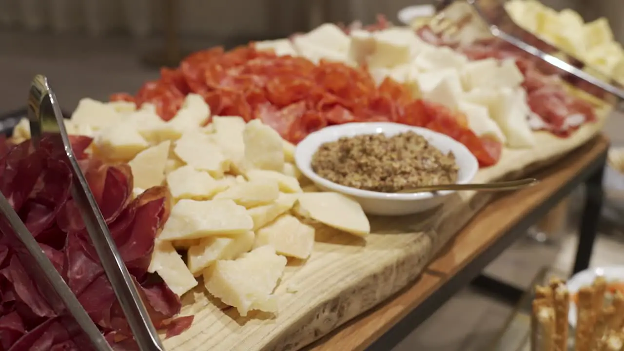 Close up of a large charcuterie board filled with meat and cheese