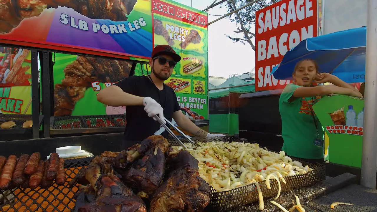 A guy stirs carnival fries at a food booth at the Orange County fair in Costa Mesa California