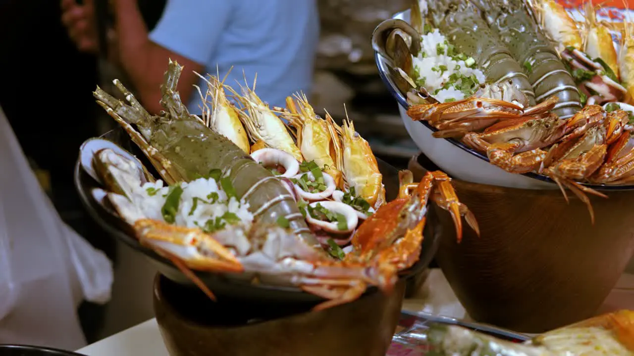 Street food stall Buckets fresh seafood on local market Ratchada Bangkok