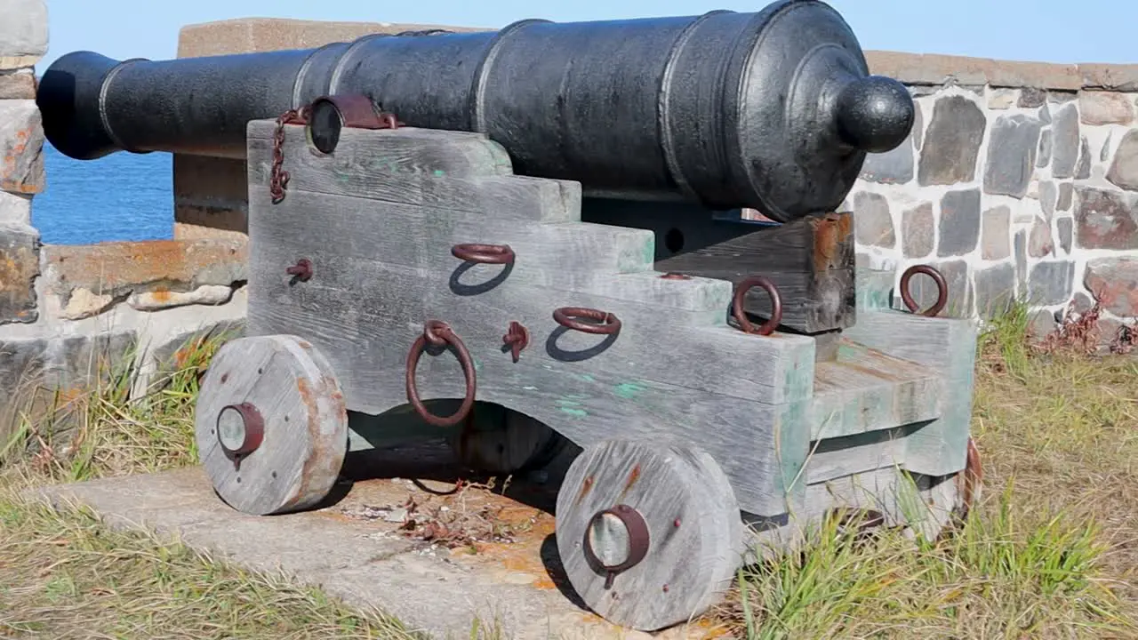 Medieval cannon at a stone wall panning right in Churchill Manitoba Canada