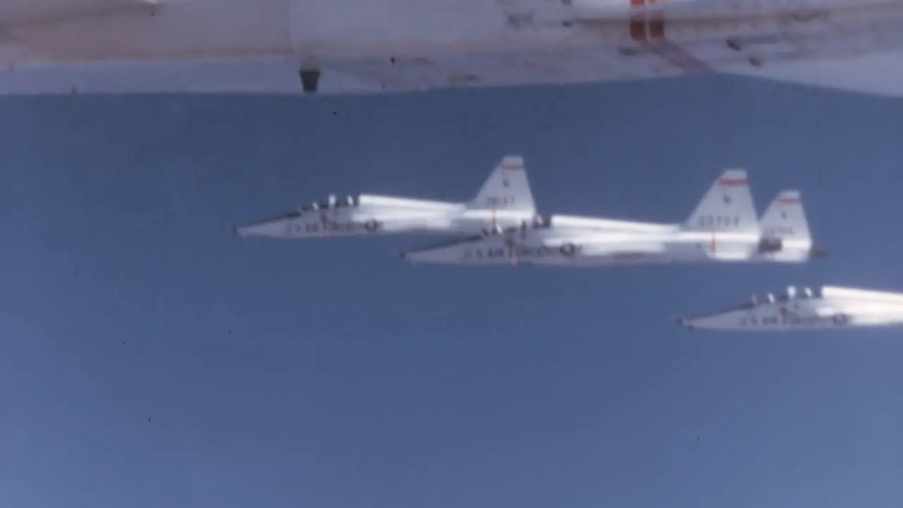 Tight Formation of 1960s USAF T-38 Talons Fighter Cockpit POV in Blue Sky