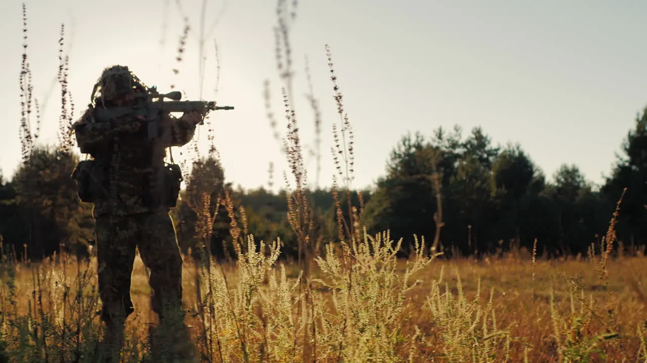 Silhouette Of Armed Men Taking Aim Through The Weapon Goes Ahead