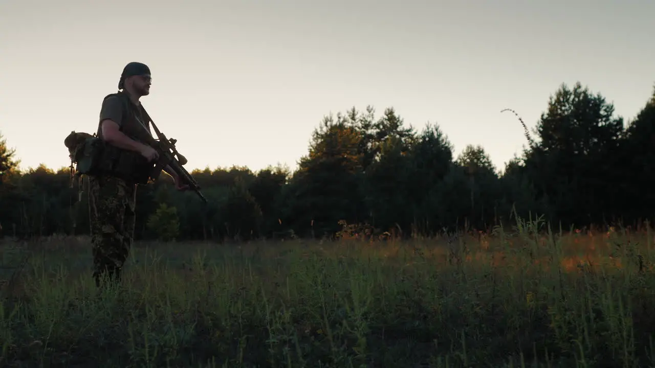 An Armed Man Running In The Attack Holding In Hands The Weapon In The Setting Sun