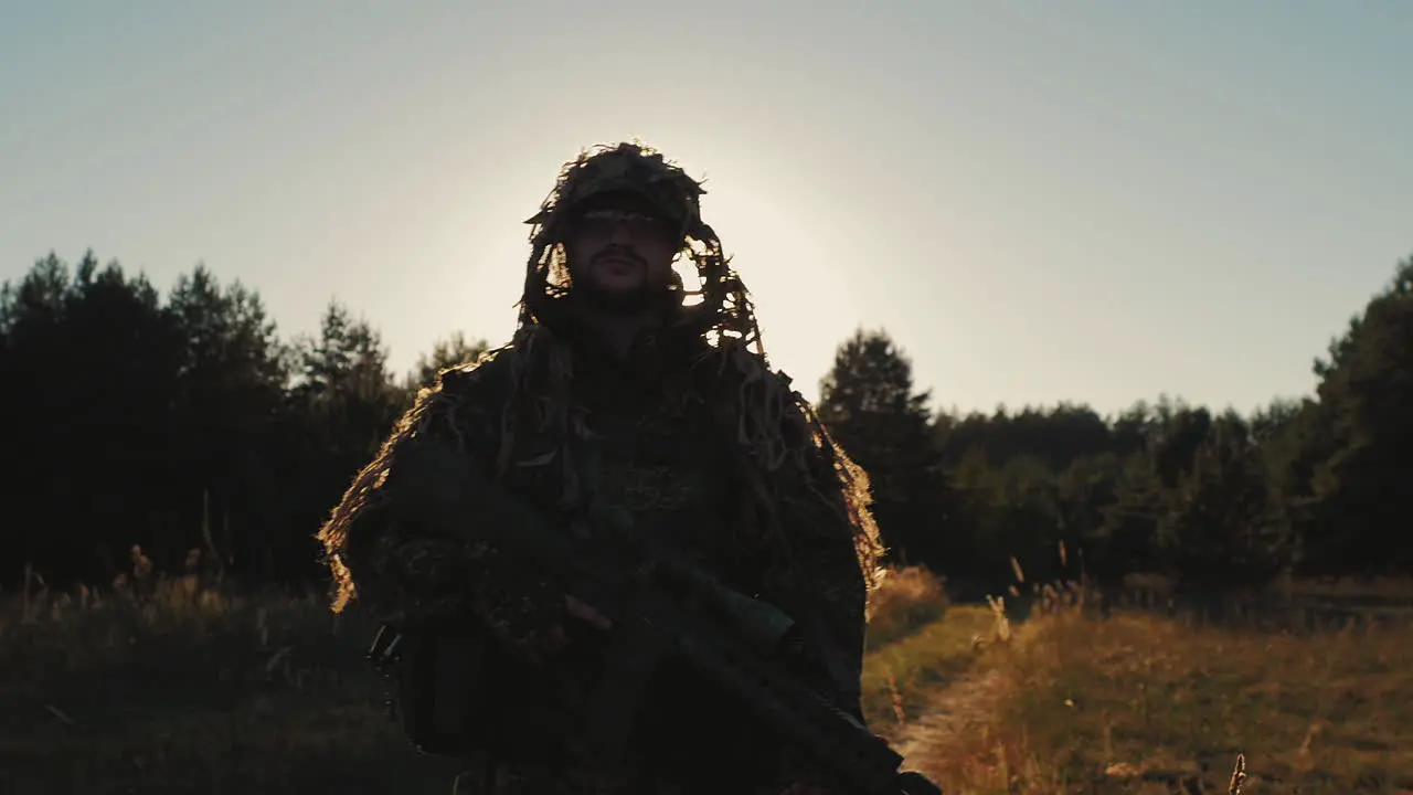 Armed With A Man Walking On A Country Road At Sunset