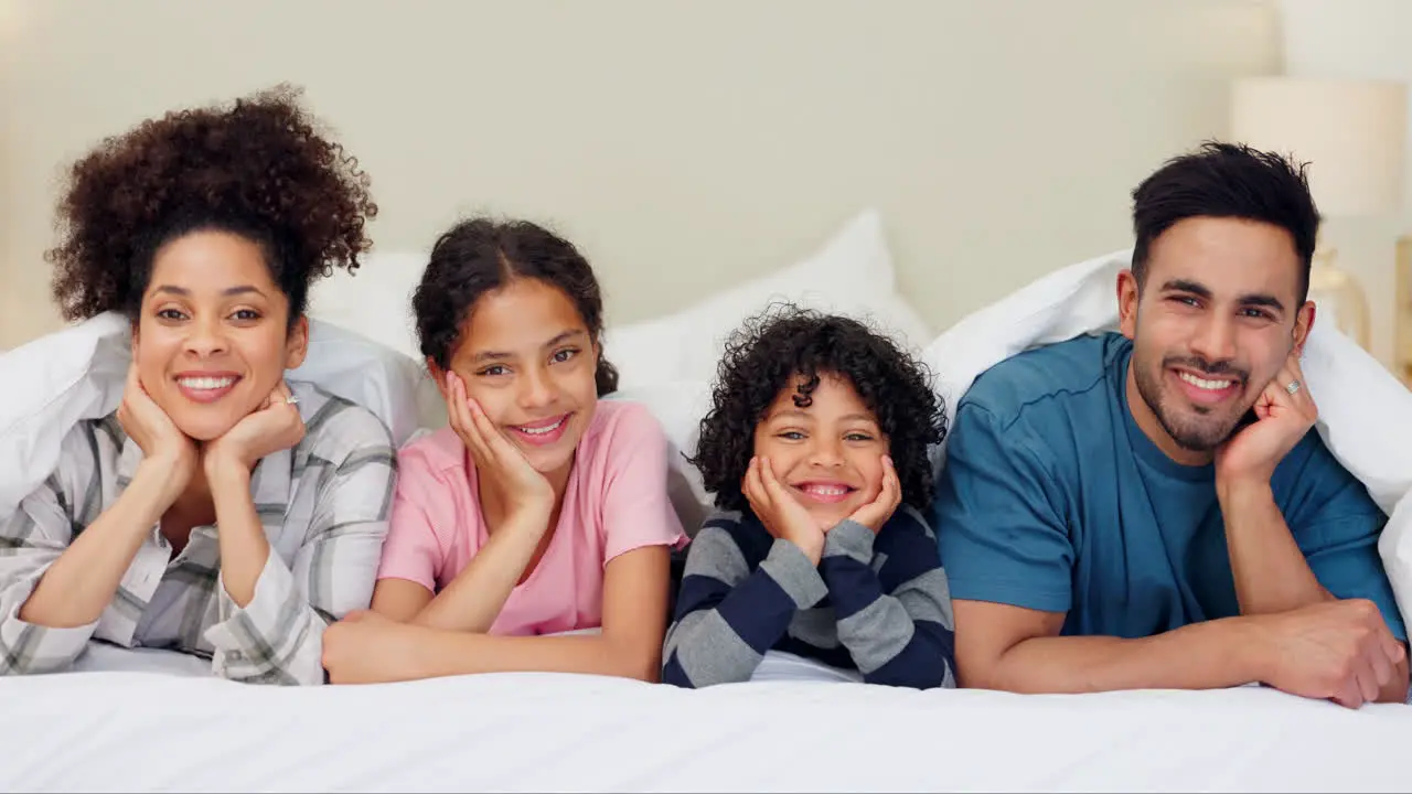 Face love and happy family relax on a bed