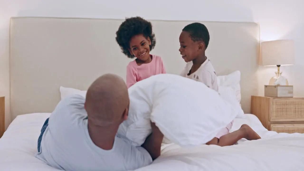 Happy family children and father with pillow