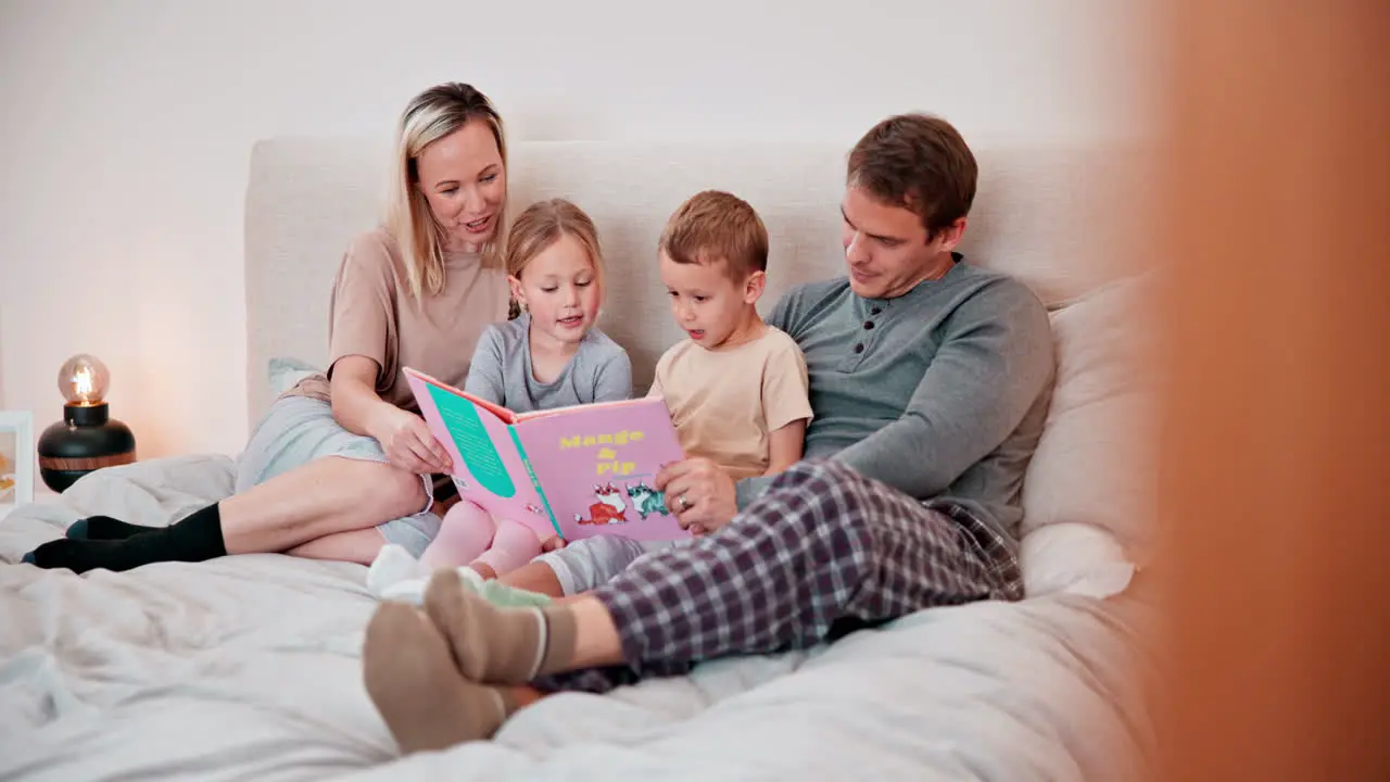 Parents kids and reading books in bed