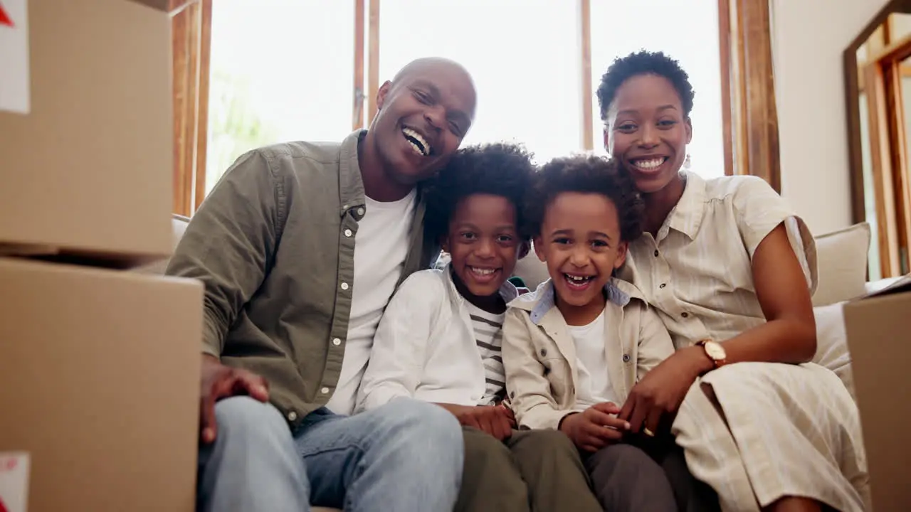 Happy black family box and sofa in new home