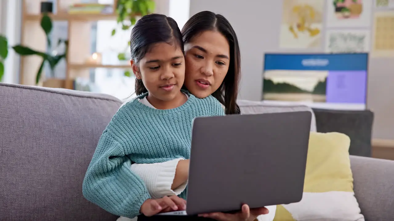 Mom girl and laptop on sofa