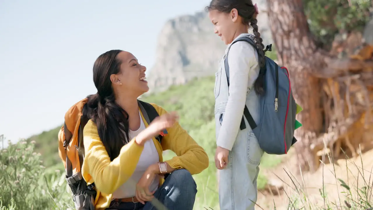 Hiking high five and mother with girl child