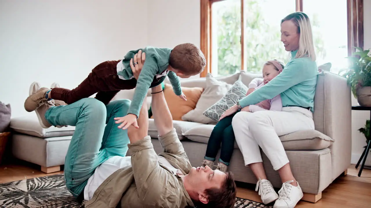 Happy playing and children with parents on a sofa