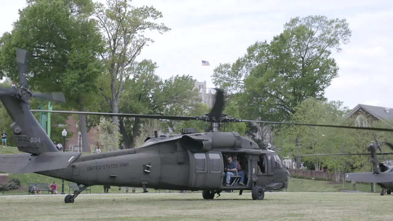 Blackhawk helicopter on the ground with it's rotors spinning ready for takeoff