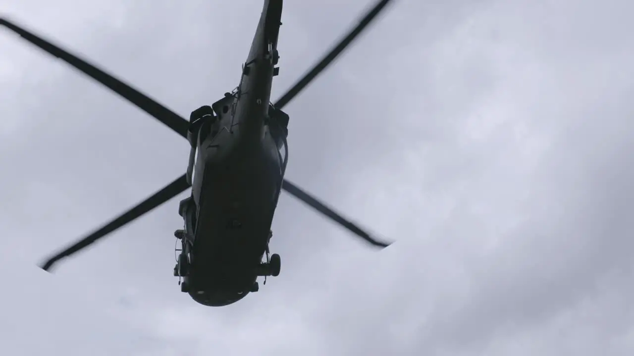 Slow motion footage of blackhawk helicopter flying overhead