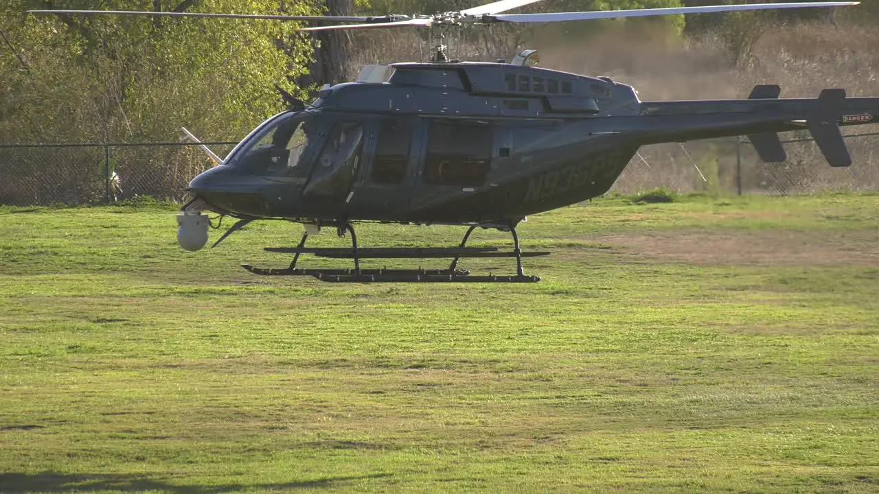 Helicopter takes off from field