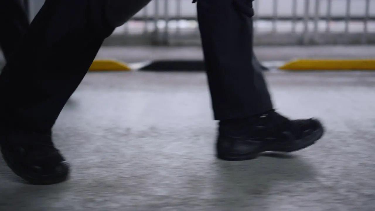 Men in black shoes walking on road