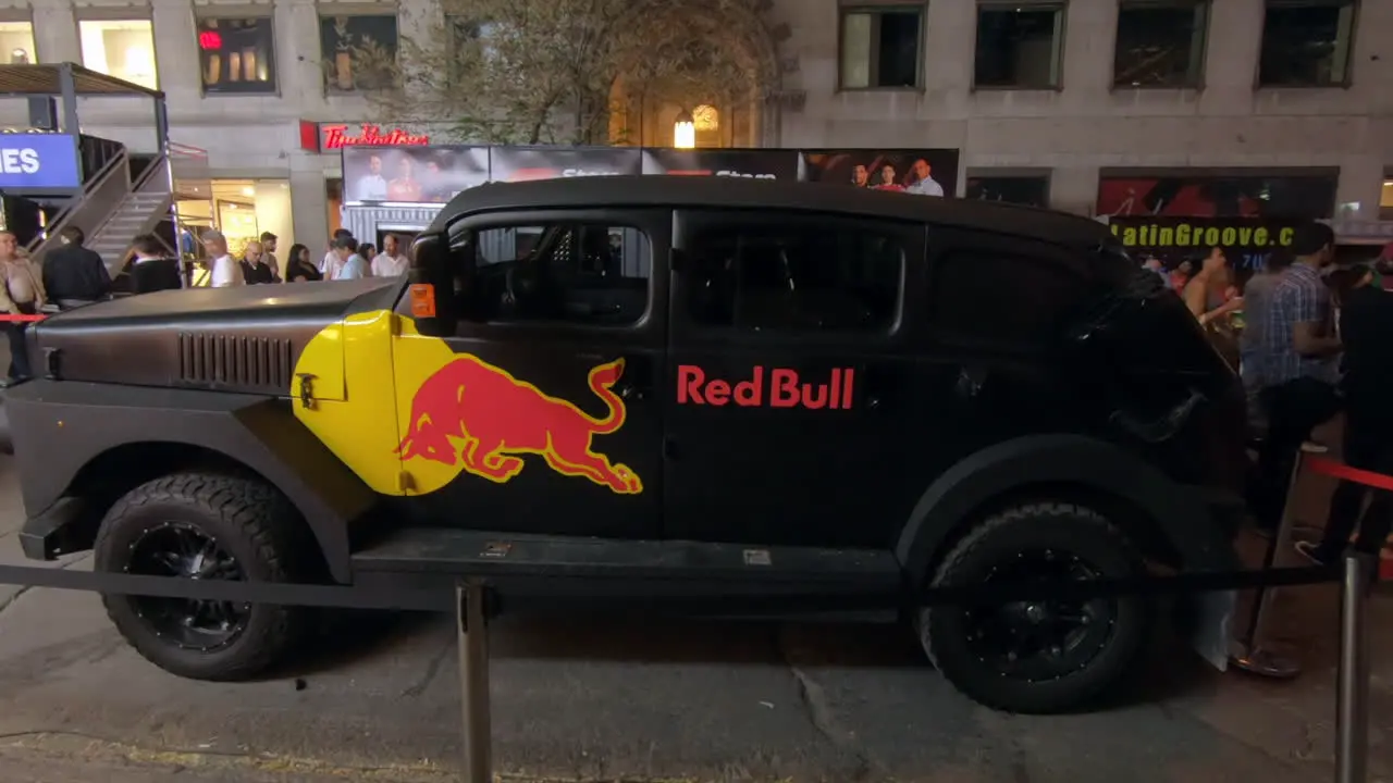 Editorial view of promotional vehicle a beautiful black truck  pick up labeled with red bull logo exposed in the street for a summer public street event