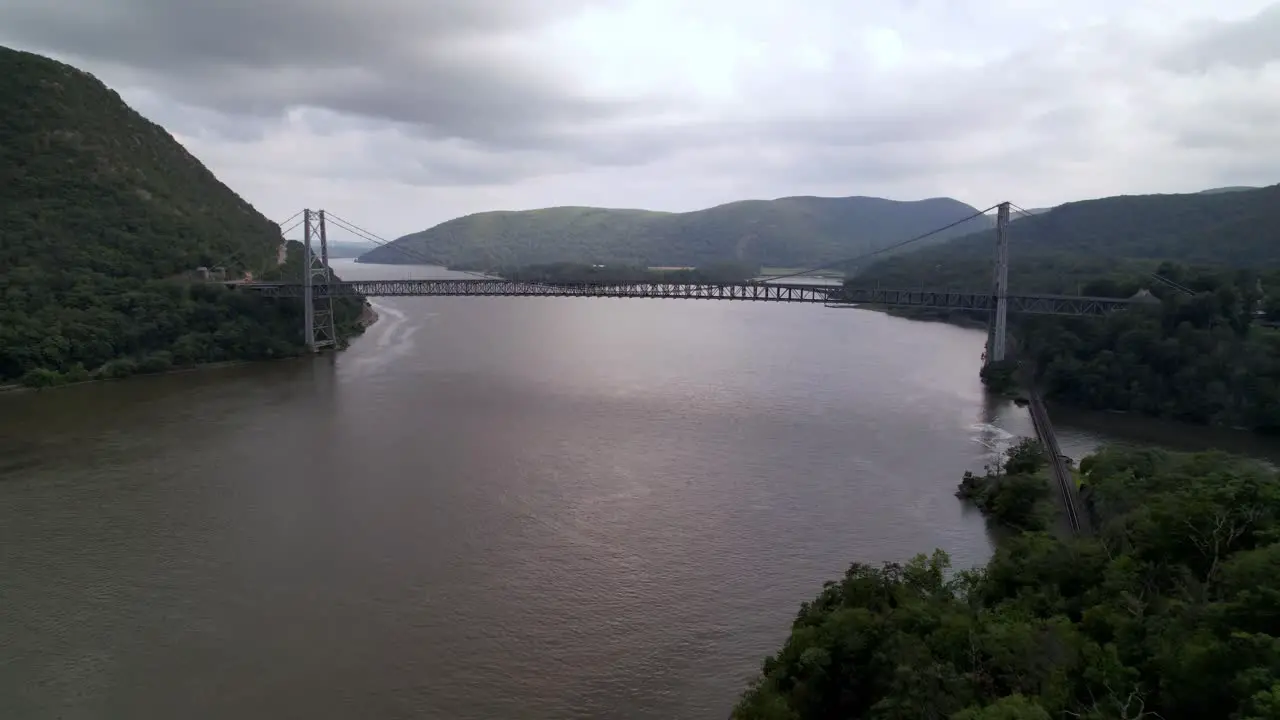 fast aerial push toward the bear mountain bridge over the hudson river near west point new york NY