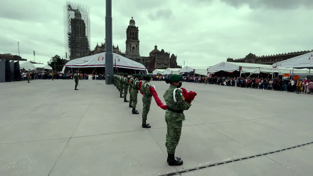 shot of members of the mexican army ordering the flag in the zocalo of mexico city