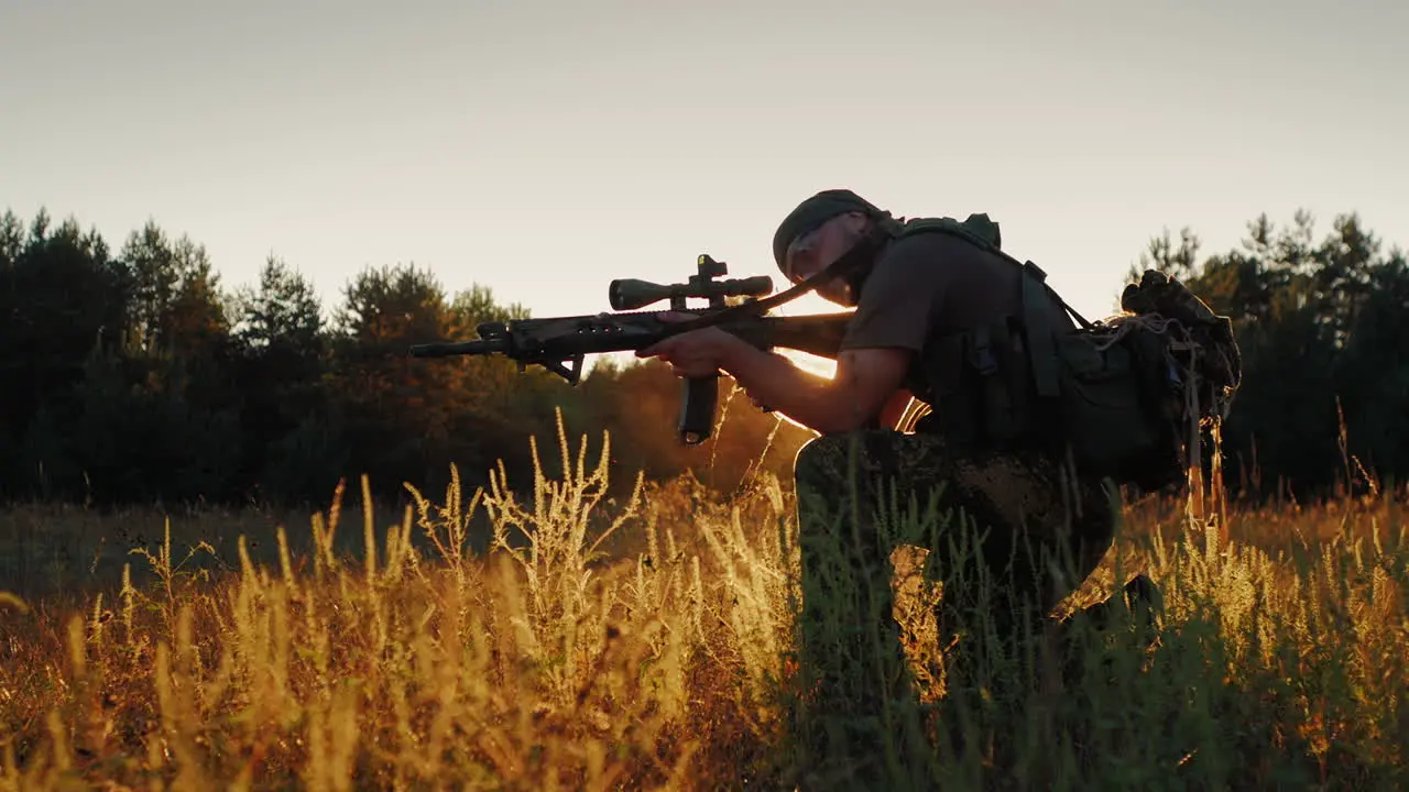 Armed Men In Camouflage It Takes Aim At The Optical Sight On The Sunset