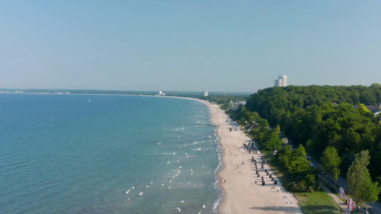 Aerial view of beach coastline in Scharbeutz Germany dolly in summertime day