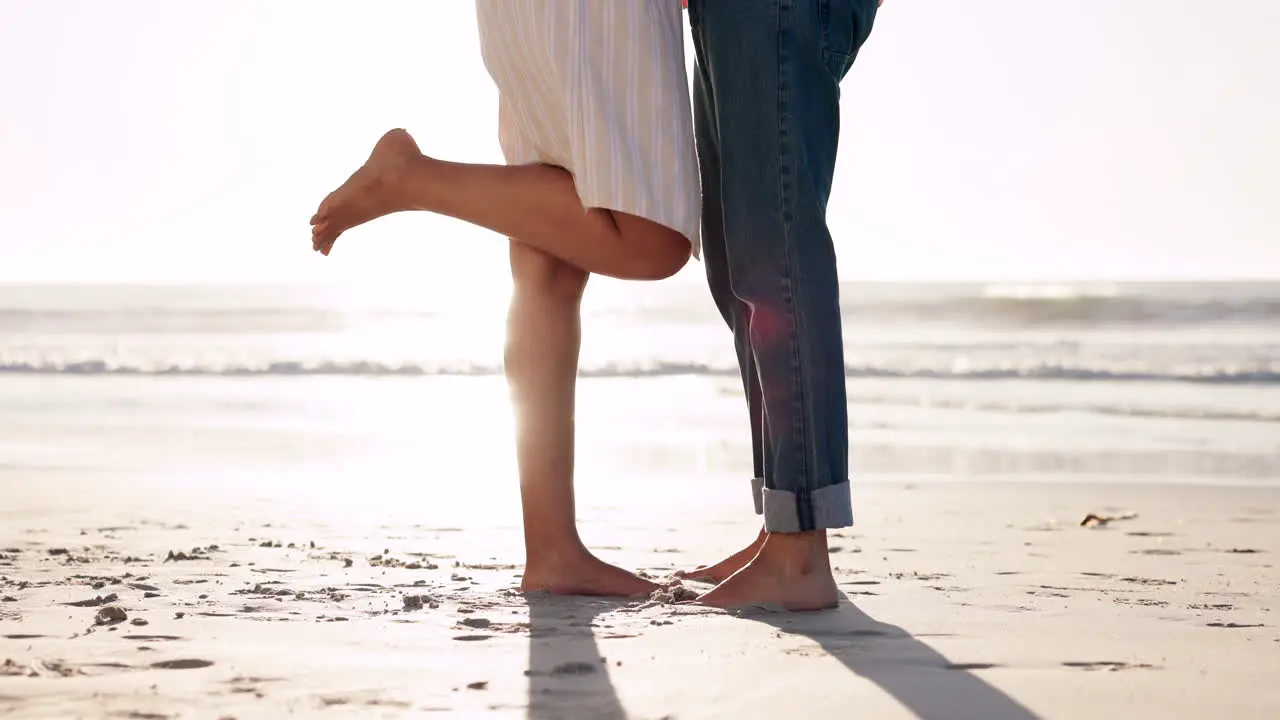 Feet legs and couple with love on a beach