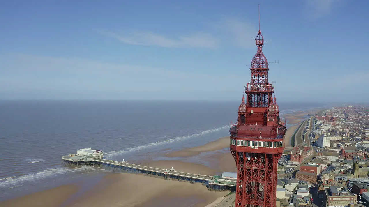 Aerial footage drone view  of the famous Blackpool Tower and beach from the sky on a beautiful Summers day on one of Great Britains most popular holiday destinations tourist attractions by the sea