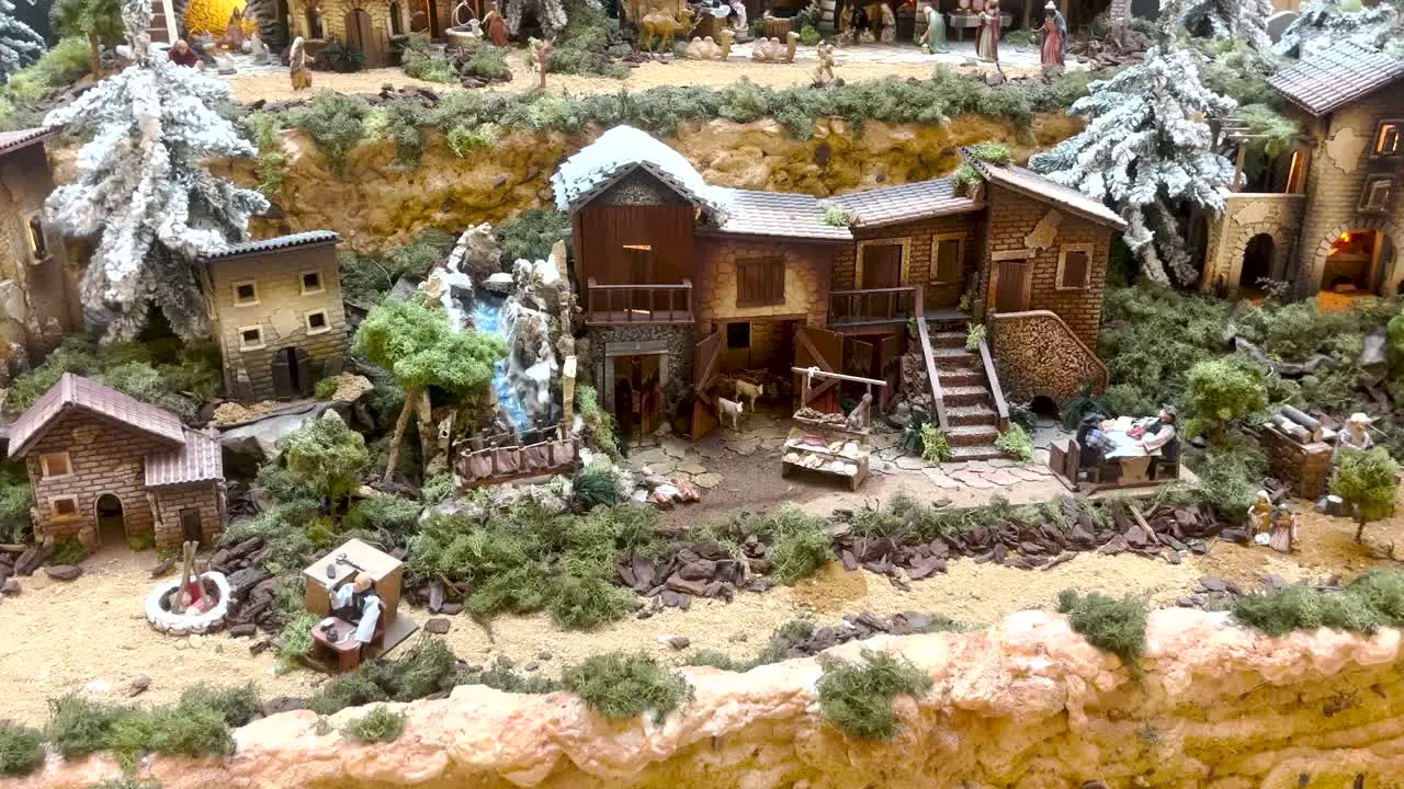 close view of whimsical miniature village adorned for Christmas blanketed in snow creating a festive and enchanting scene for playful holiday moments