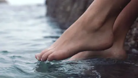 Feet of woman dip in ocean or sea on vacation