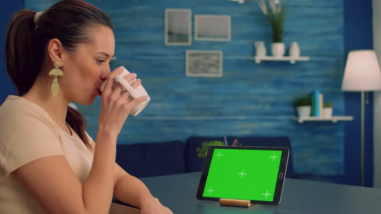 Freelancer holding touchpad with mock up green screen