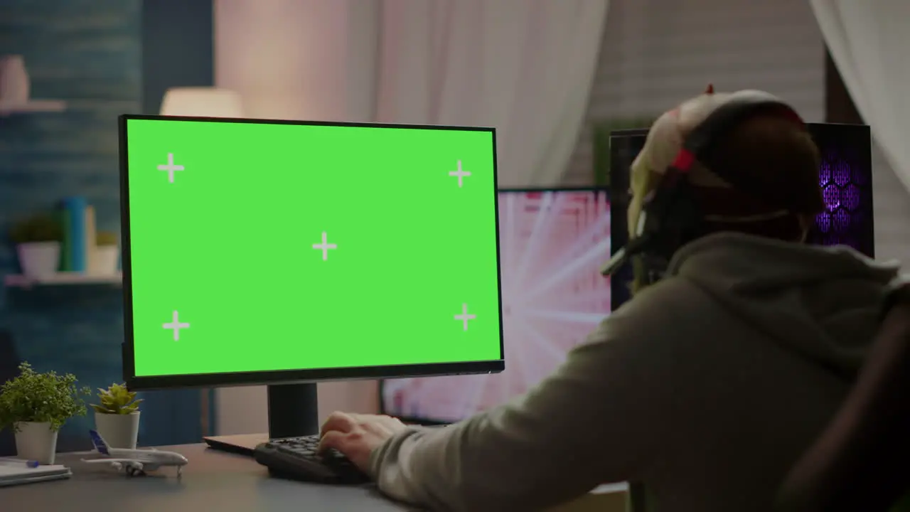 Professional cyber gamer playing video games with greenscreen