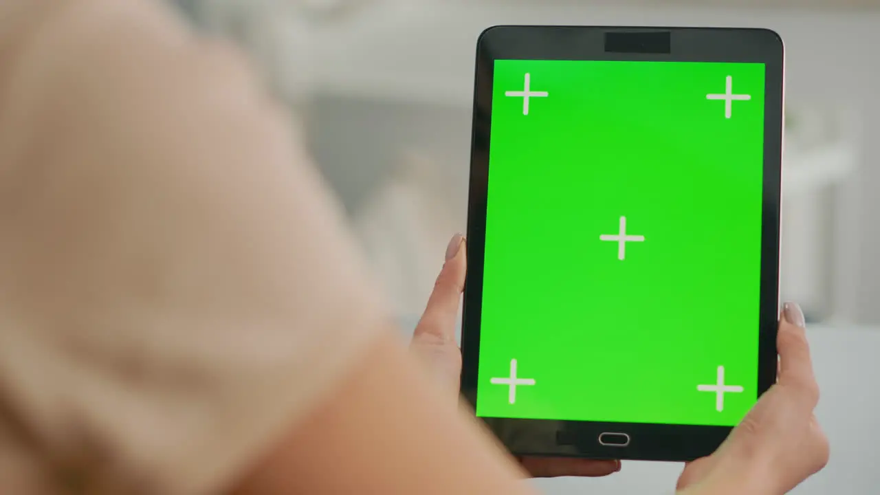 Close up of woman hands holding tablet computer with mock up green screen