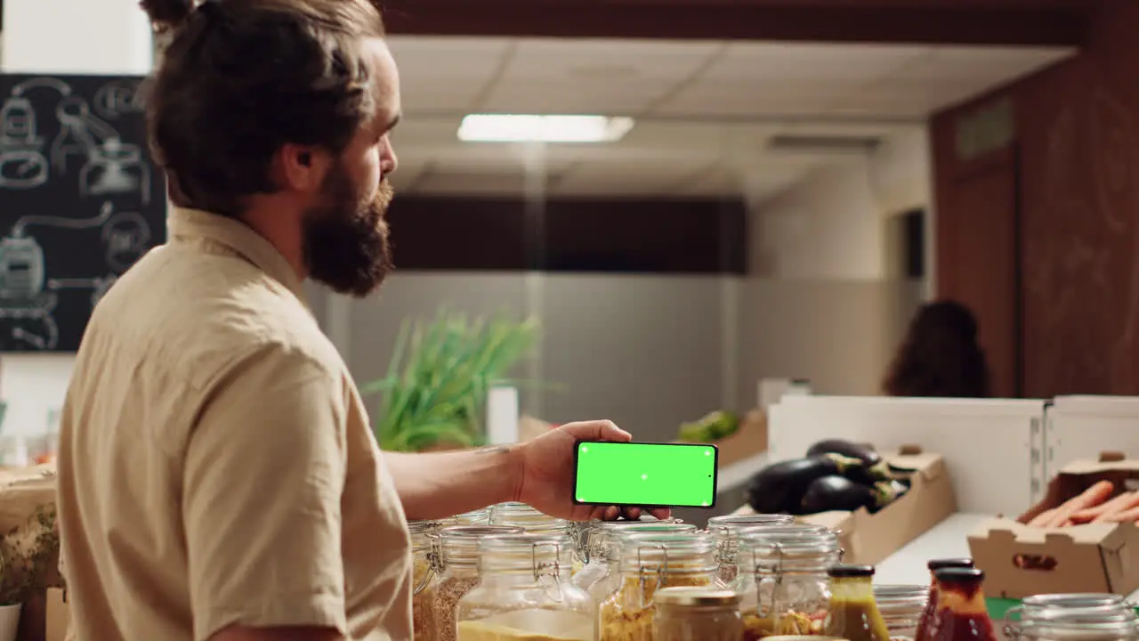 Man uses mockup phone in bio supermarket