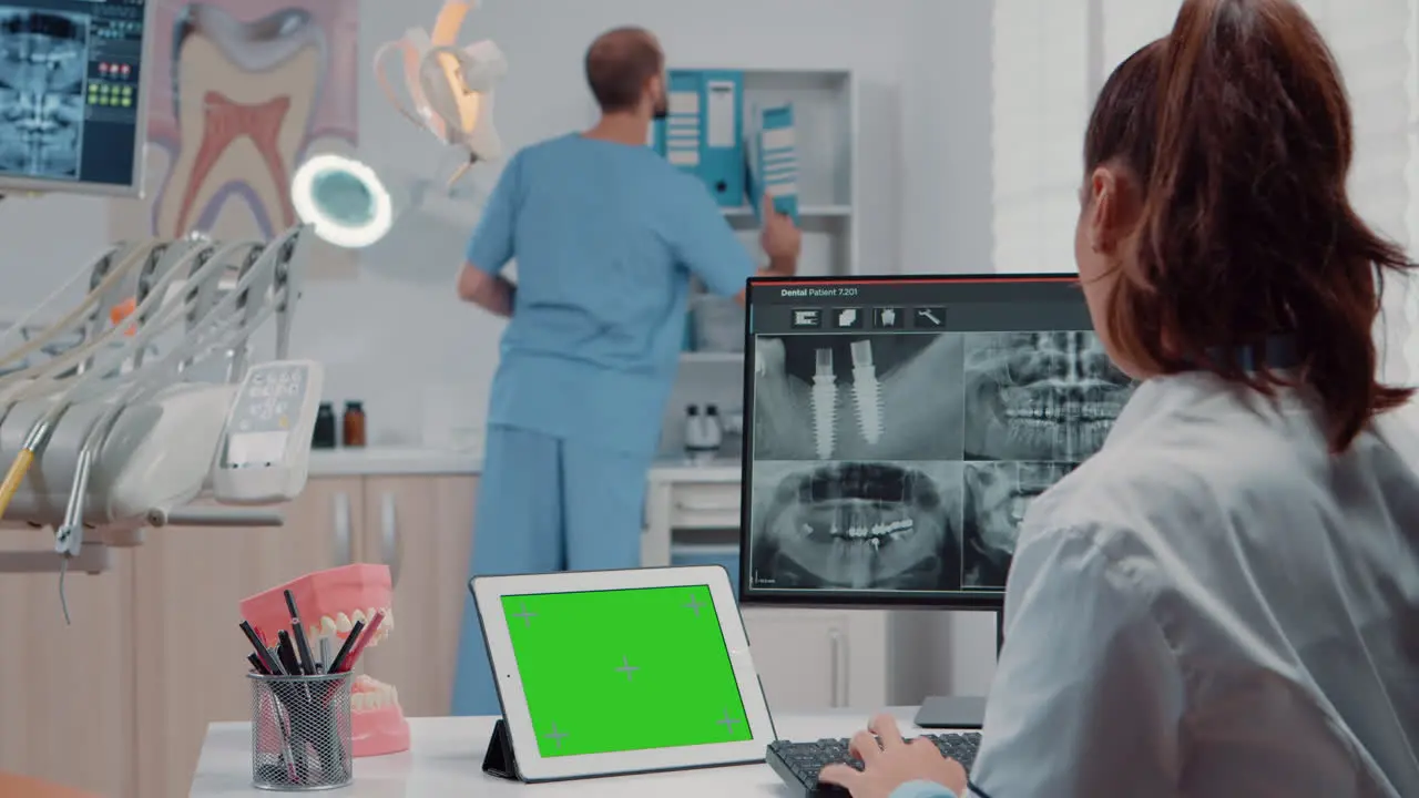 Orthodontist using horizontal green screen on tablet