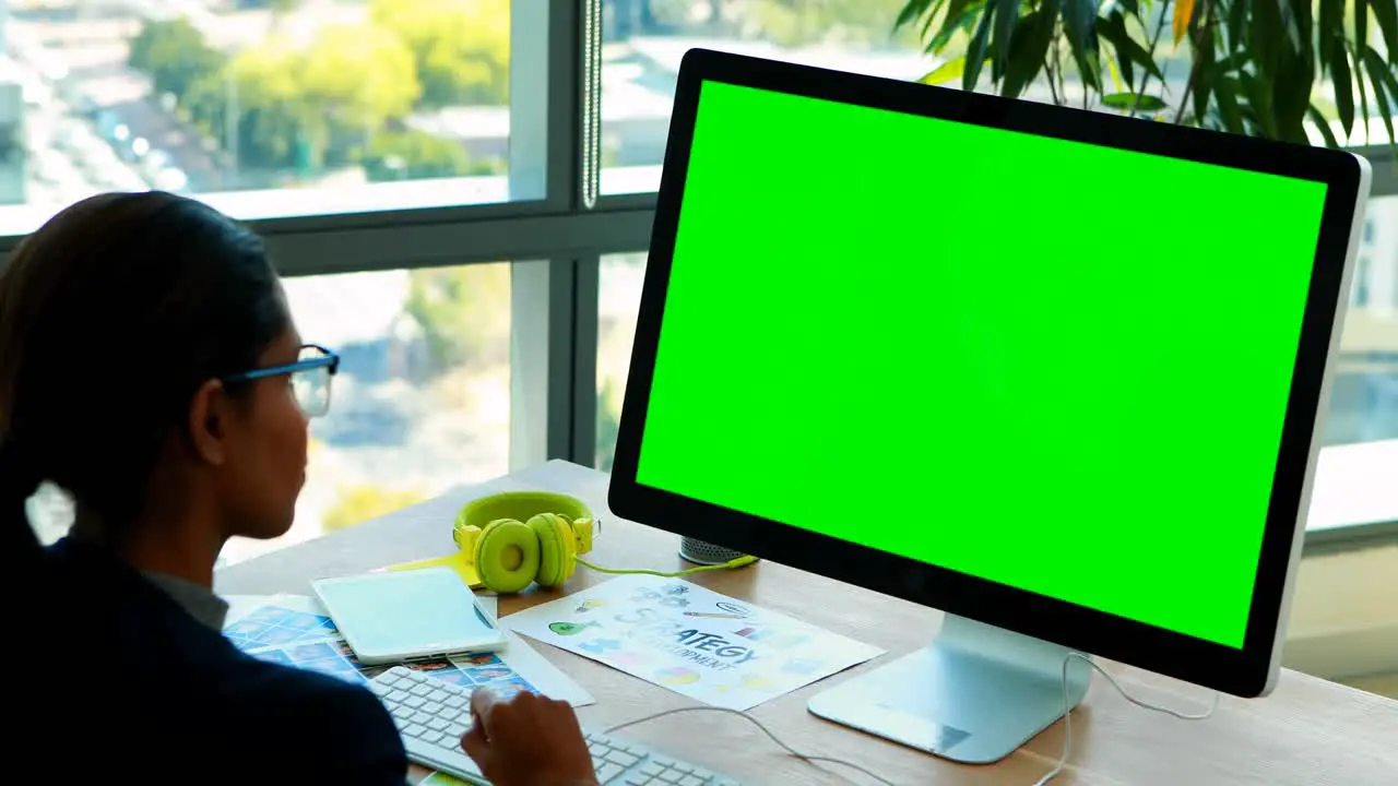 Female graphic designer working over computer at her desk