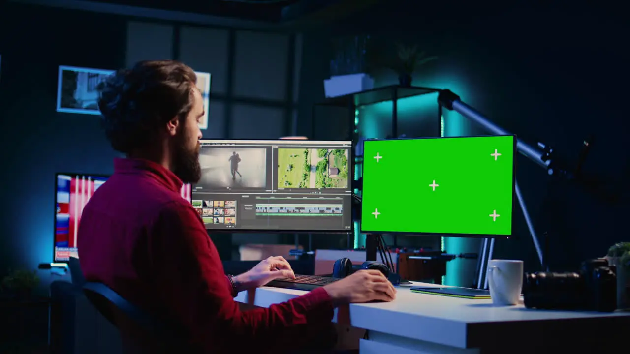 Video editor using editing software on green screen monitor to upgrade footage shot