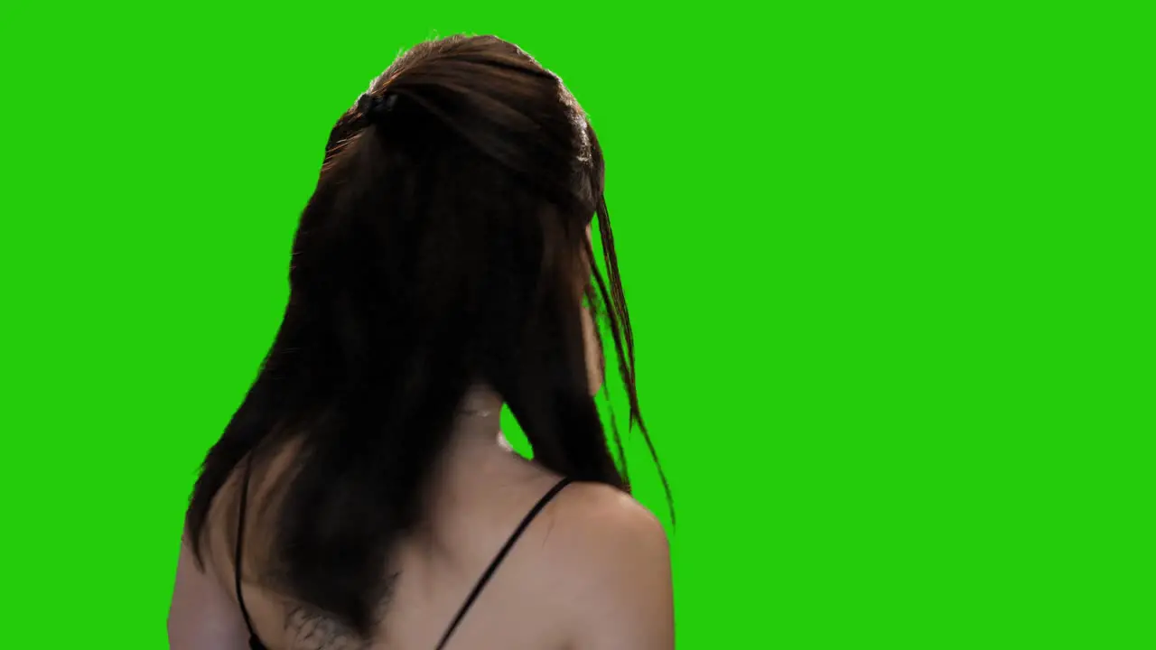 Pretty brunette woman seductively winks and walks away on green screen